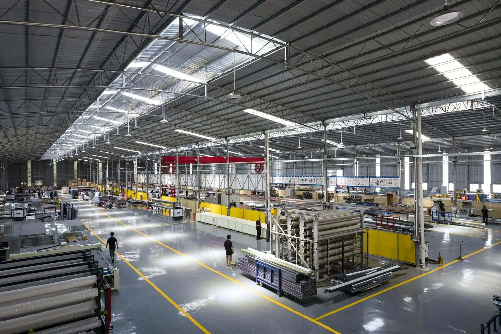 Interior view of pergola factory showing production lines and industrial equipment in operation