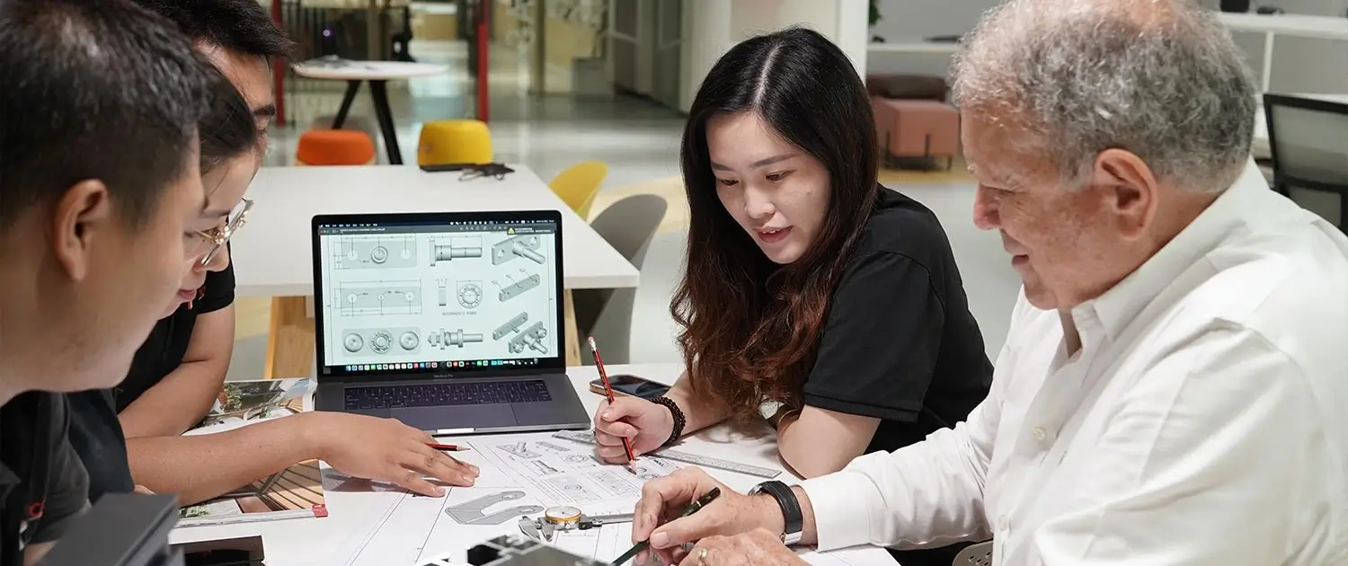 Pergola design team discussing sketches and prototypes during a collaborative brainstorming session